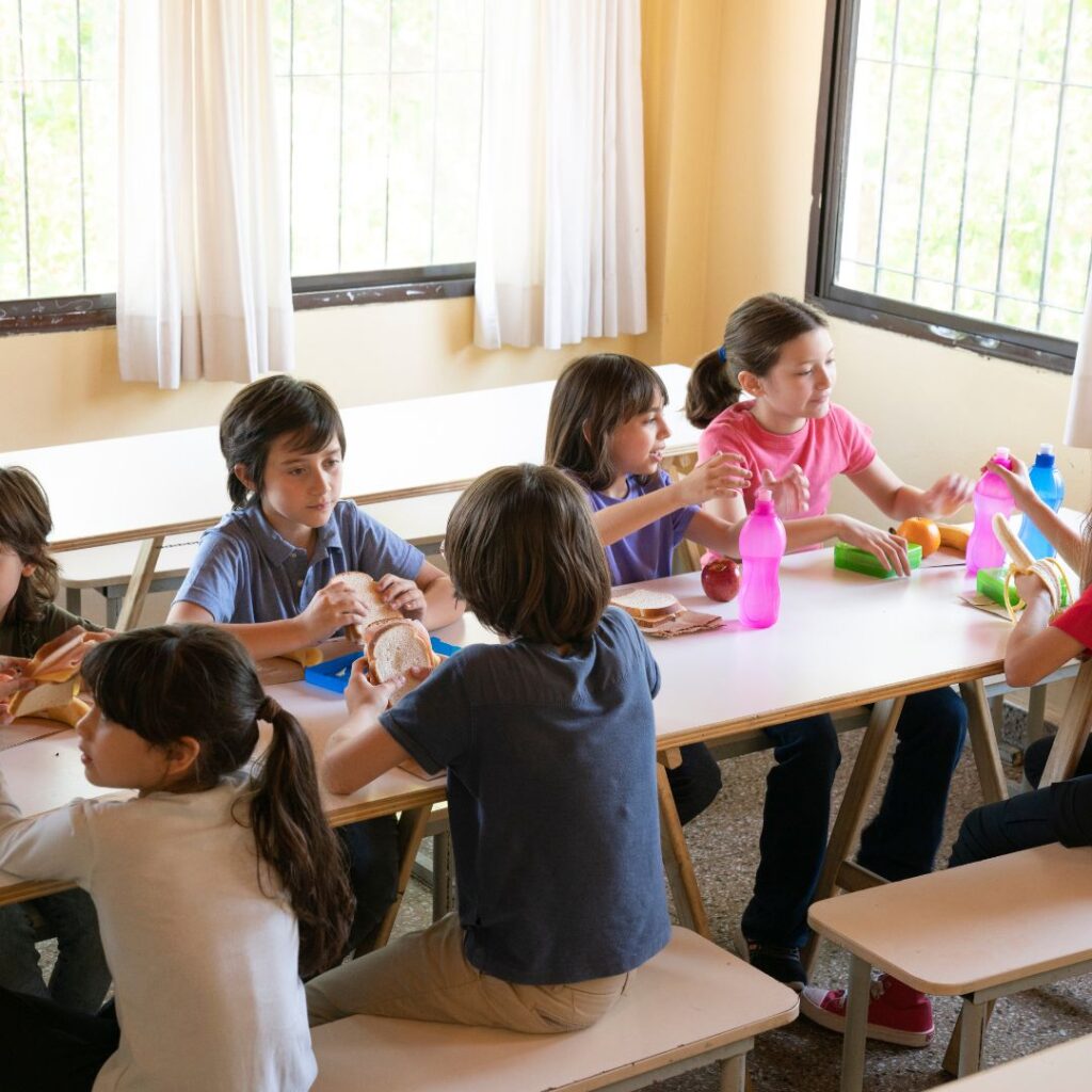Preschoolers eating lunch at table