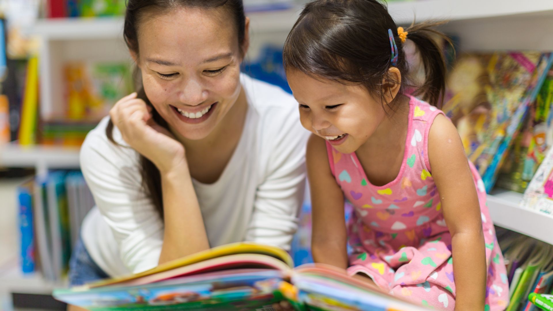 a mom reading to her daughter