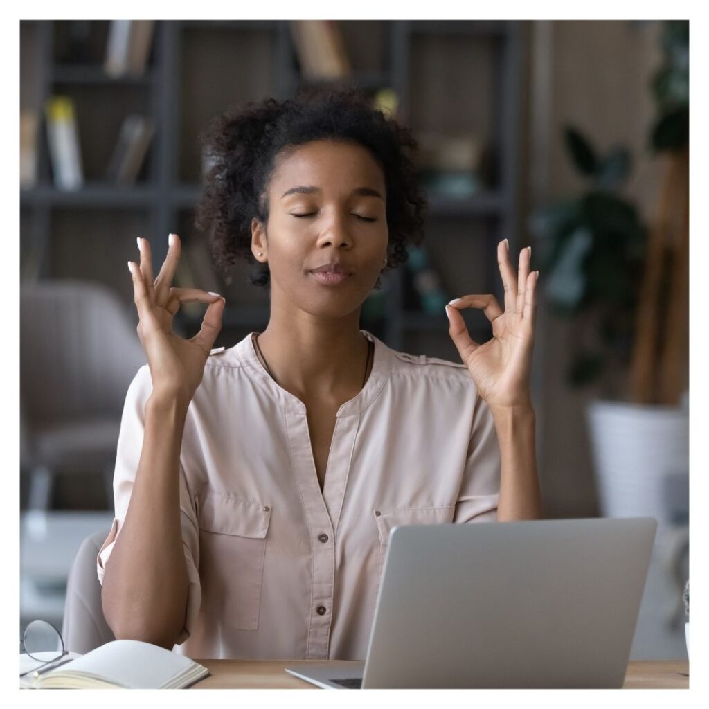 Woman practicing mindfulness at work.